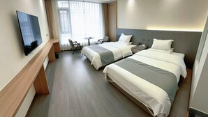 A hotel room with two beds, a TV, a desk, and a window with curtains. - Lugu Lake Yongzhen Hotel (Ninglang)
