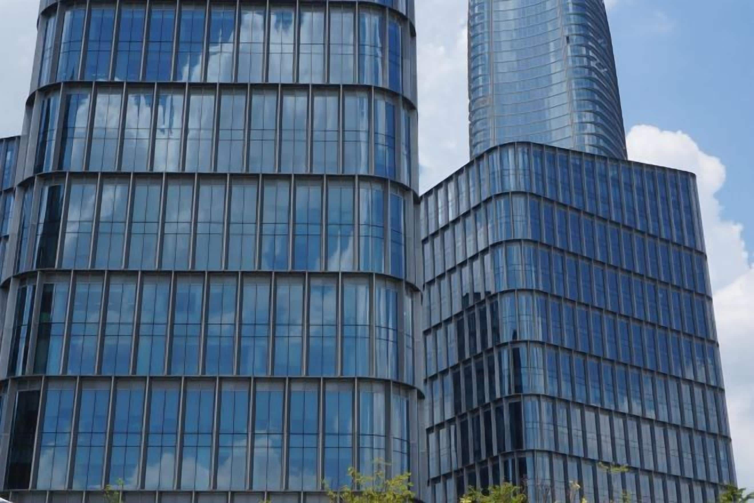 A modern building with a curved facade and large windows.
