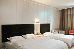 A hotel room with two beds, a nightstand, a lamp, a chair, and a view of the outdoors. - Libo Jiaxin Hotel (Libo)
