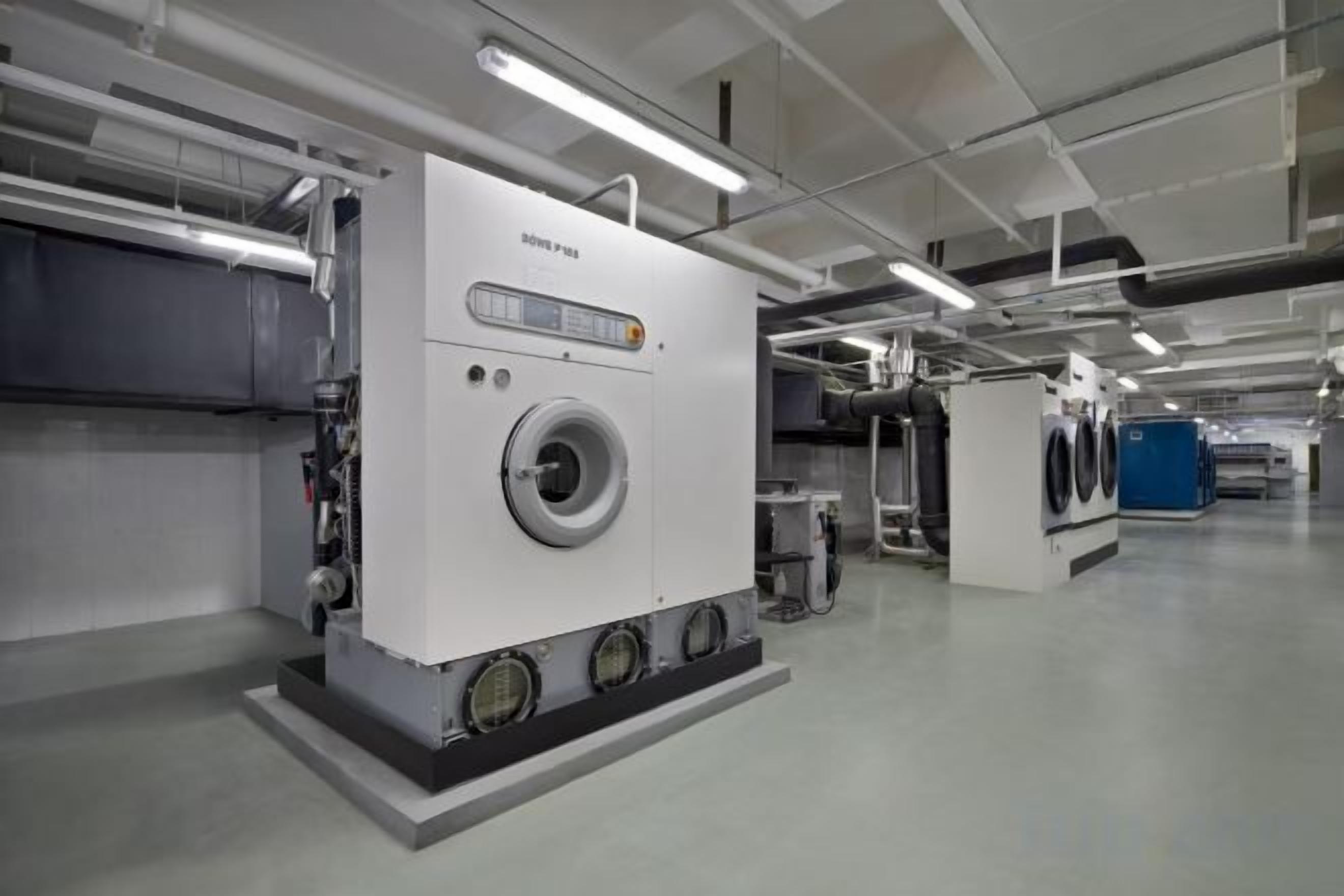 A large industrial machine, possibly for laundry or manufacturing, in a clean, well-lit industrial setting.