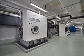 A large industrial machine, possibly for laundry or manufacturing, in a clean, well-lit industrial setting. - Yi Qiao Hotel (Chengdu)
