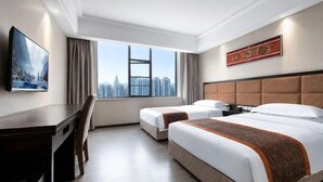 A hotel room with a city view, two beds, a desk, and a chair. - Teng Chuan Hotel (Lichuan)