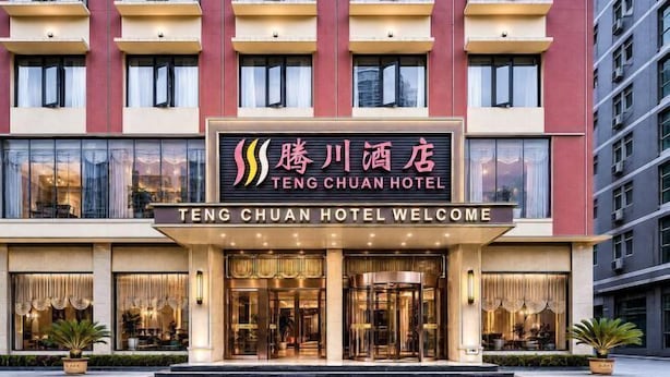 A hotel with a prominent entrance, large windows, and a sign indicating it's the Teng Chuan Hotel. - Teng Chuan Hotel (Lichuan)