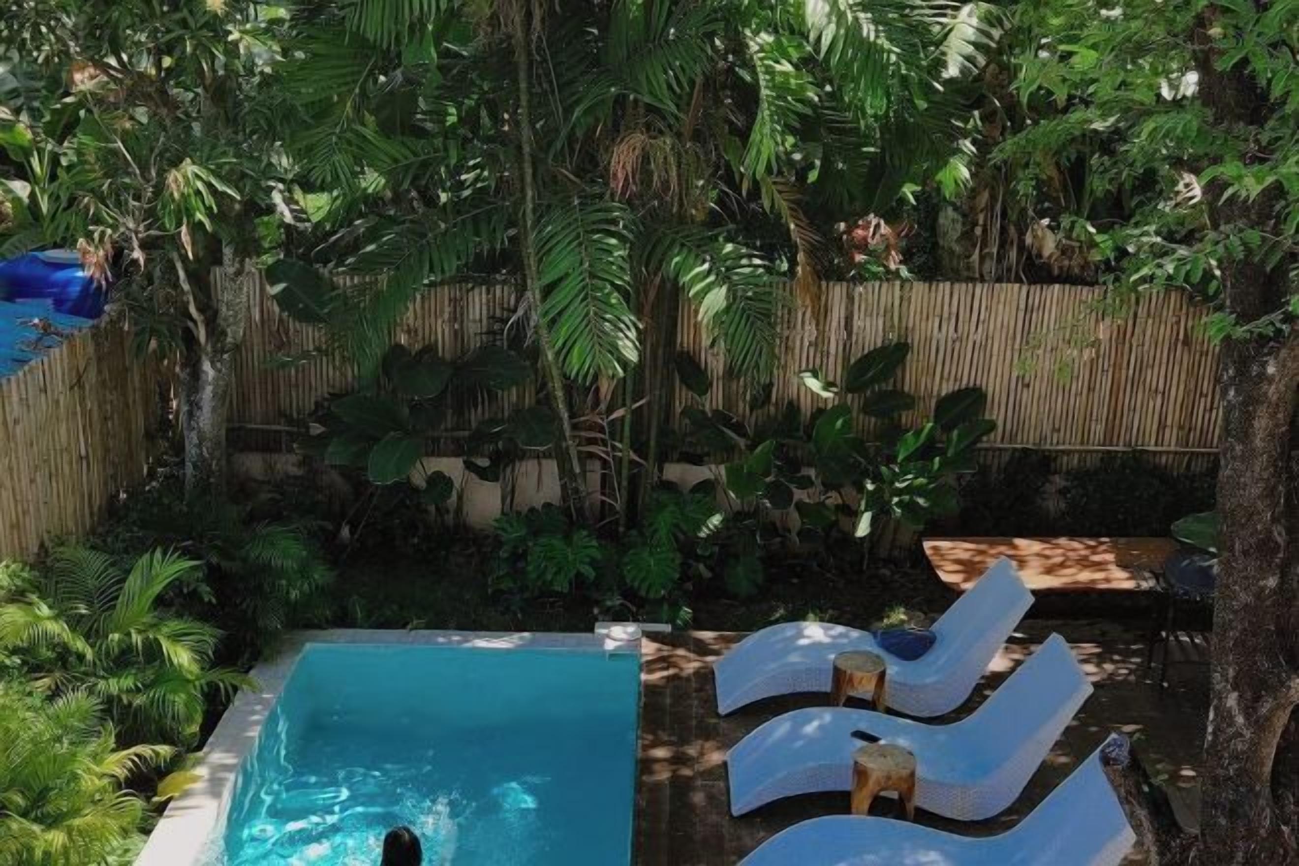 Ein Schwimmbecken mit Liegestühlen und einer Holzterrasse.
