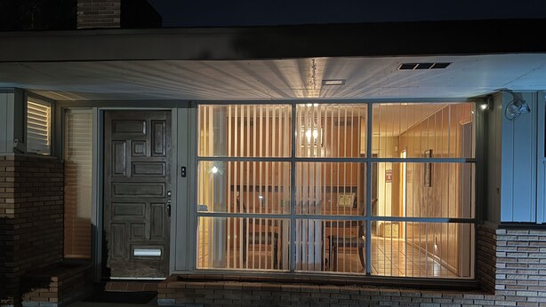 A modern house with a large glass door and a brick exterior. - NEAR CAMPUS! Choice KING or QUEEN BEDS w fresh interior paint & great parking! (College Station)