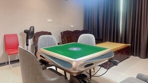 A room with a pool table, chairs, a fan, and a window with curtains. - Shell Hotel (Zhuhai Doumen Daxin Xinduhui) (Zhuhai)