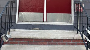 A red door with a white trim, a mailbox, and a house number 169. - Fidelia Room Fuchsite (Irvington)