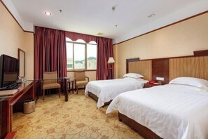 A hotel room with two beds, a desk with a television, a chair, and a window with curtains. - Yinwan Hotel( South China country garden store) (Guangzhou)