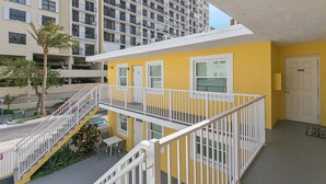 A yellow building with white railings, a door, and a window. - ULTRA exciting Apartment at Boardwalk  (Hollywood)