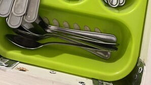 A green utensil holder with a knife, fork, spoon, and other cutlery. - Comfortable, Within Walking Distance To The Beaches 2217
 (Hallandale Beach)