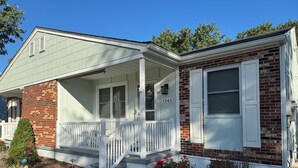 A two-story house with a porch, a brick exterior, and a number '1343' on the front wall. - Charming 3-bedroom house in beautiful Cape May, NJ (Cape May)