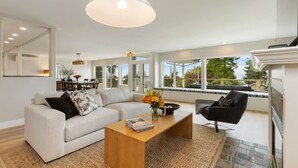 A spacious living room with a sofa, coffee table, and a fireplace.