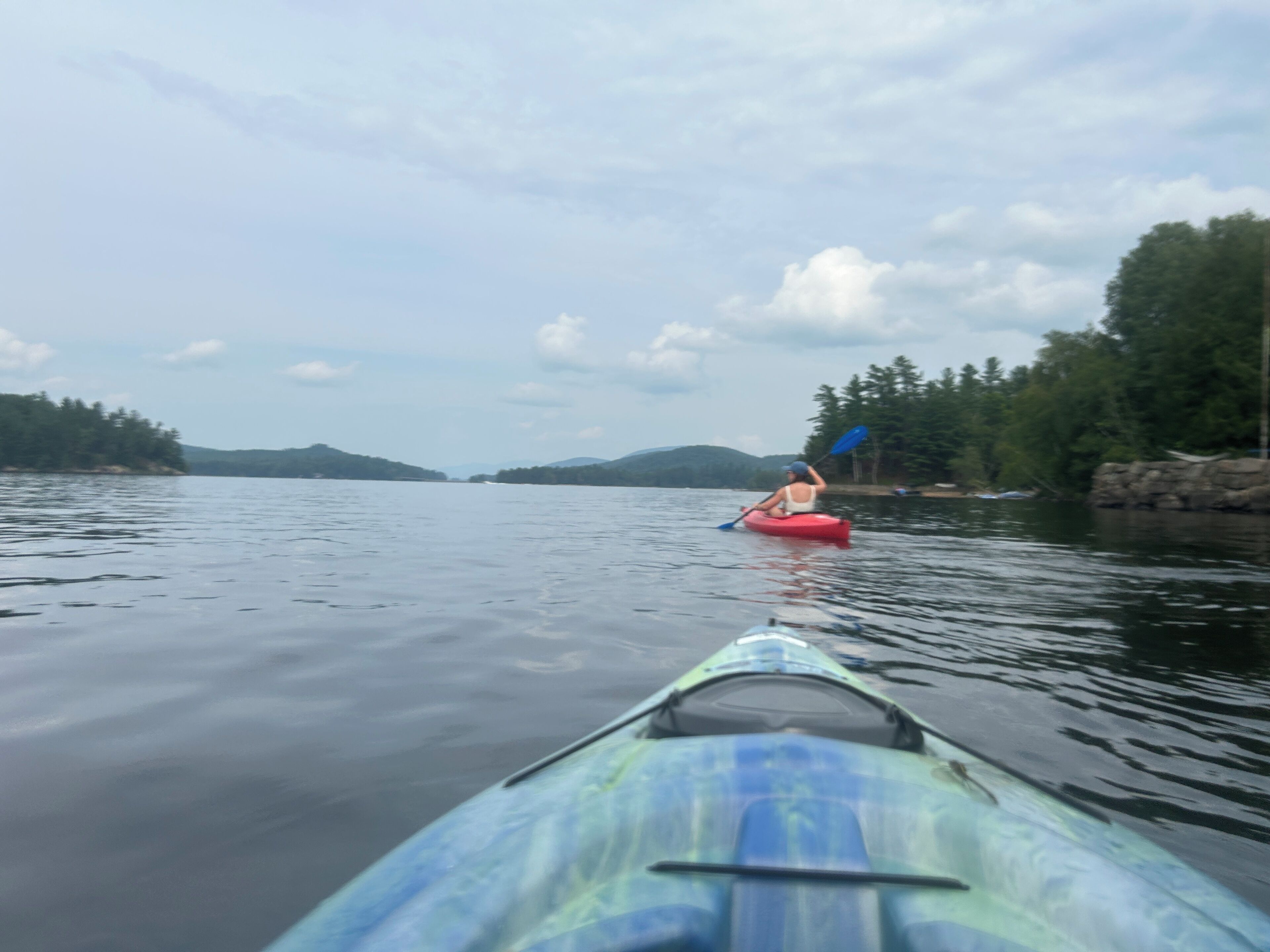 A kayak on calm water with a person paddling.
