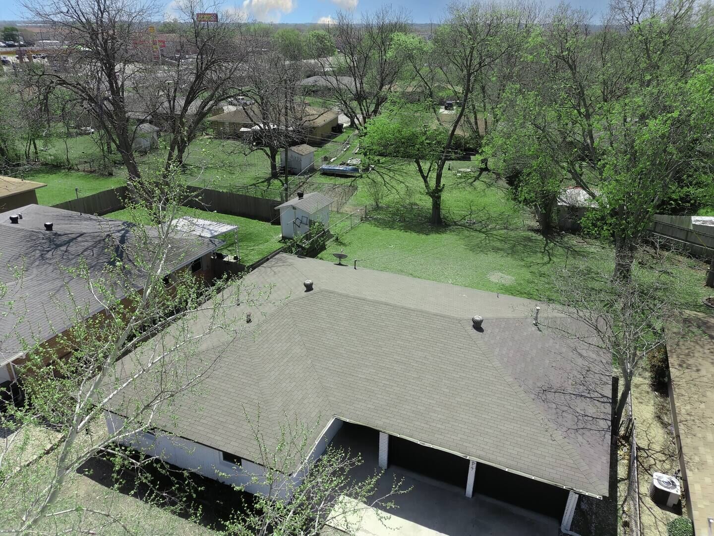 A residential area with multiple houses, each featuring a garage and a sloped roof.