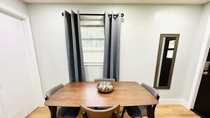 A dining room with a wooden table, six chairs, and a bowl on the table. - Trendy & Central 2 Bedroom Apt (Fort Lauderdale)