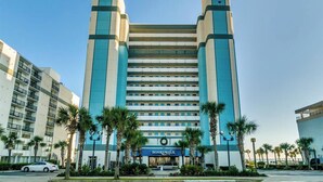 A mid-rise hotel with a central atrium, multiple floors, and a prominent 'Boardwalk' sign at the ground level. - Pristine Oceanfront Suite with Enticing Views (Myrtle Beach)