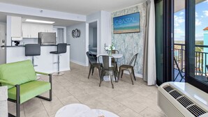 A modern apartment with a kitchen, dining area, and balcony. - Remodeled Dec23/Best Floorpan/DogsOK (Myrtle Beach)