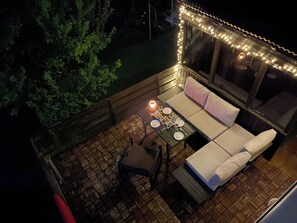 An outdoor seating area with a table, chairs, and a sofa.