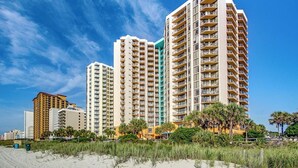 A beachfront hotel with multiple high-rise buildings, featuring balconies and a sandy beach in the foreground. - Paradise Awaits @ Oceanfront Suite/Dogs OK! (Myrtle Beach)