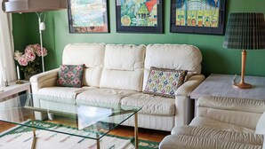 A living room with a sofa, a glass coffee table, and a patterned rug. - 7 Person Holiday Home in Skummeslovsstrand (Skummesloevsstrand)