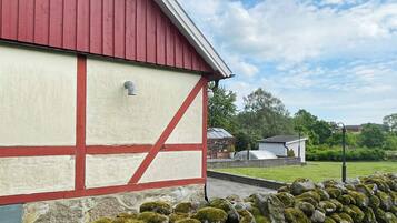 A red and white building with a stone wall in front.