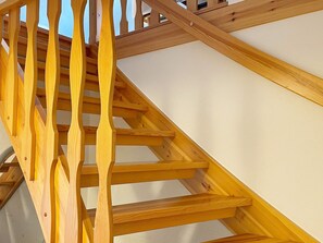 A wooden staircase with a handrail and steps, leading to an upper level. - 4 Person Holiday Home in Lovestad (Lövestad)