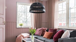 A cozy living room with a grey sofa, a glass coffee table, and a black woven pendant light. - 4 Star Holiday Home in Garsnas (Gärsnäs)