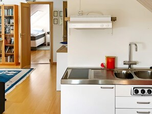 A compact kitchen with a sink, stove, and a small countertop. - 4 Star Holiday Home in Frillesas (Frillesas)
