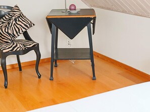 A room with a chair and a small table, both with black metal frames. - 4 Star Holiday Home in Frillesas (Frillesas)