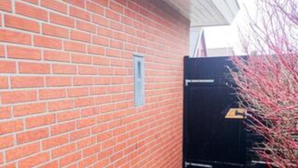 A brick building with a door and a small window. - 4 Star Holiday Home in Blokhus (Blokhus)