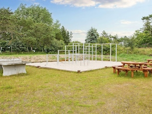 A playground with metal structures and picnic tables. - 5 Star Holiday Home in Romo (Rømø)