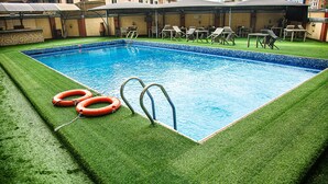 A rectangular swimming pool with two ladders and two orange life rings on the edge. - Lavender Spa and Suites (Enugu)