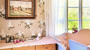 A cozy room with a wooden dresser, a framed landscape painting, and a window with a view of greenery. - 4 Star Holiday Home in Bralanda (Bralanda)