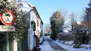 A narrow snow-covered street with a building on the left. - Modernized Holiday Home With Terrace (Munstergeleen)