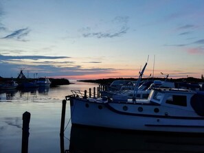 A marina with boats docked at the pier during sunset. - 5 Person Holiday Home in Tarm (Tarm)