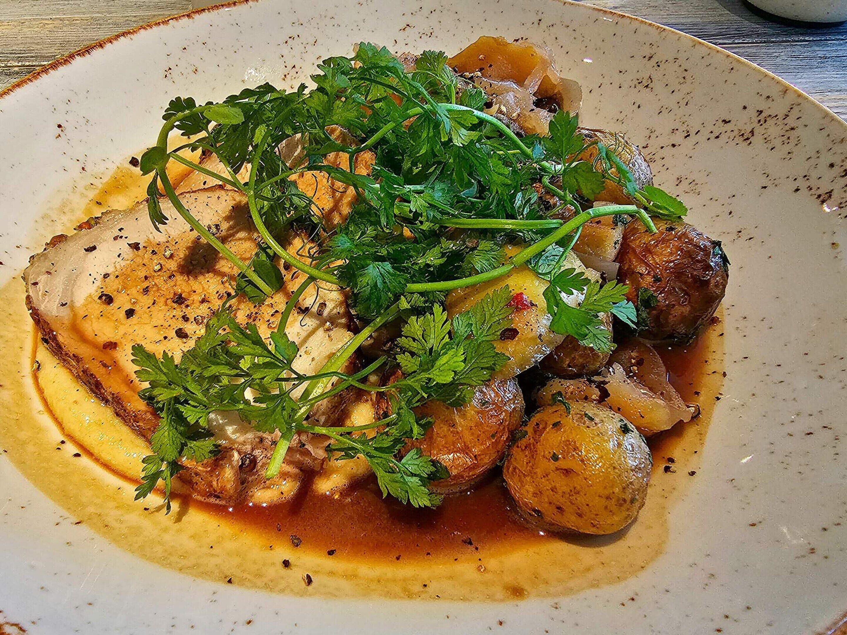 A plate of food with a garnish of green herbs.