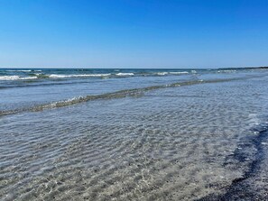 A beach with clear water and waves. - 8 Person Holiday Home in Skivarp (Skivarp)