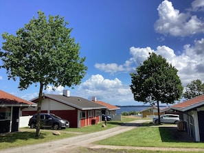 A residential area with houses, a dirt road, and trees. - 5 Person Holiday Home in Aabenraa (Aabenraa)
