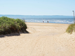 A sandy beach path leading to the ocean with a clear sky. - 4 Star Holiday Home in Skummeslovsstrand (Skummesloevsstrand)
