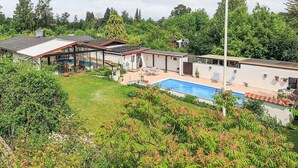 A residential property with a swimming pool, a covered patio, and a large garden area. - 5 Person Holiday Home in Frederiksvaerk (Frederiksvaerk)