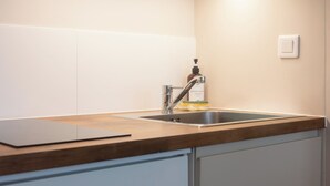 A kitchen with a stainless steel sink, a wooden countertop, and a dishwashing liquid bottle. - Superb Bordeaux flat in hypercentre for *4 people* (Bordeaux)