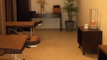 Relax in a serene space with a massage table, desk, and potted plant.