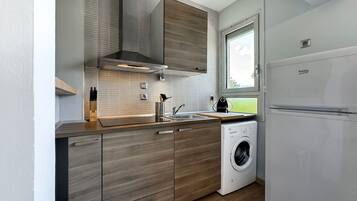 Fridge, toaster, cookware/dishes/utensils, dining tables