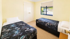 A room with two beds, a window with a view of a parked car, and a door. - Meelup Ridge (Dunsborough)