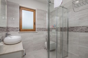 A modern bathroom with a large sink, a toilet, and a glass shower enclosure. - 3BR Istrian Villa Erla w/ Private Pool, Labin, Croatia (Labin)
