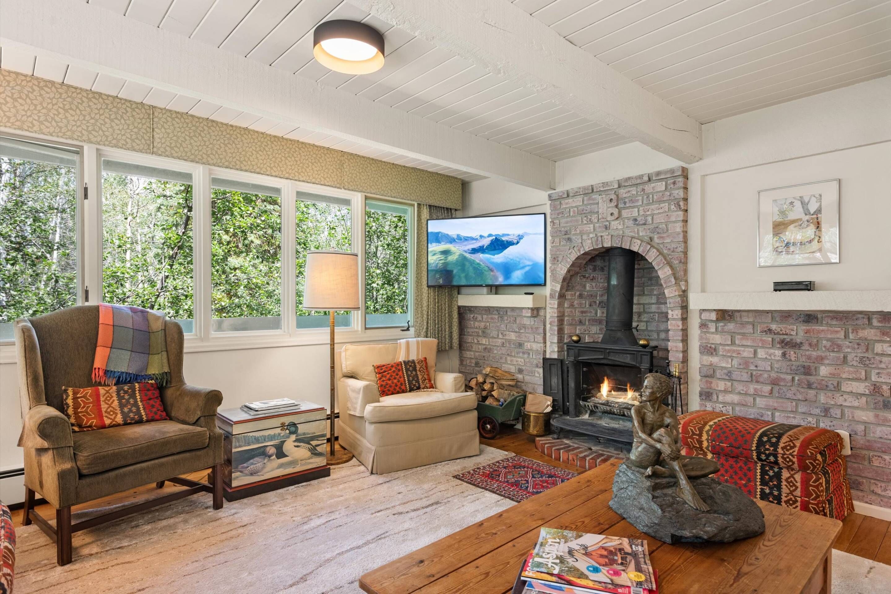 The family room offers cozy seating, a wood burning stove and a flat screen TV.