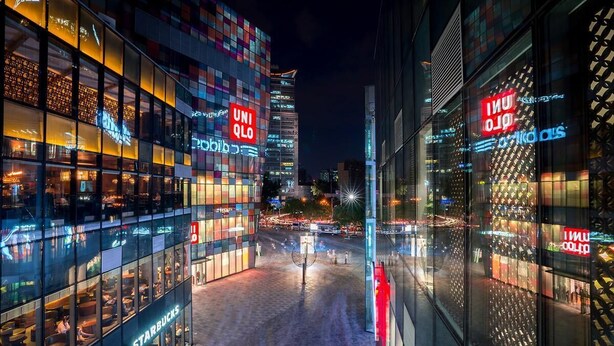 A modern urban building with multiple storefronts, including a Starbucks and a UNIQLO store. - Tangfu Hotel Sanlitun Gongti Branch (Beijing)