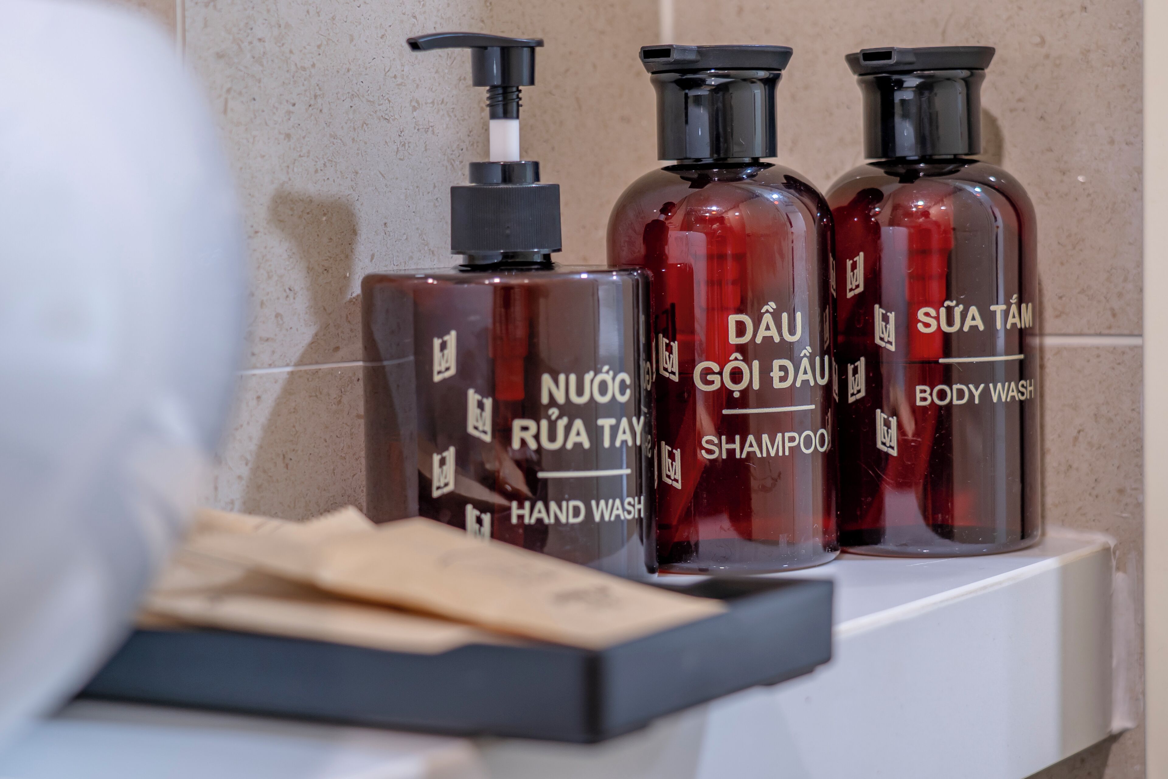 Three bottles of body wash and hand wash on a shelf.