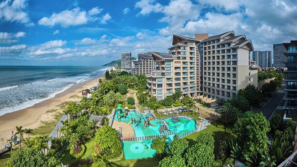 A beachfront hotel with a large pool area, multiple buildings, and a view of the ocean. - Artel Shanwei - Xinghai Resort (Shanwei)