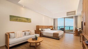 A modern hotel room with a bed, sofa, and a balcony with a view. - Artel Shanwei - Xinghai Resort (Shanwei)